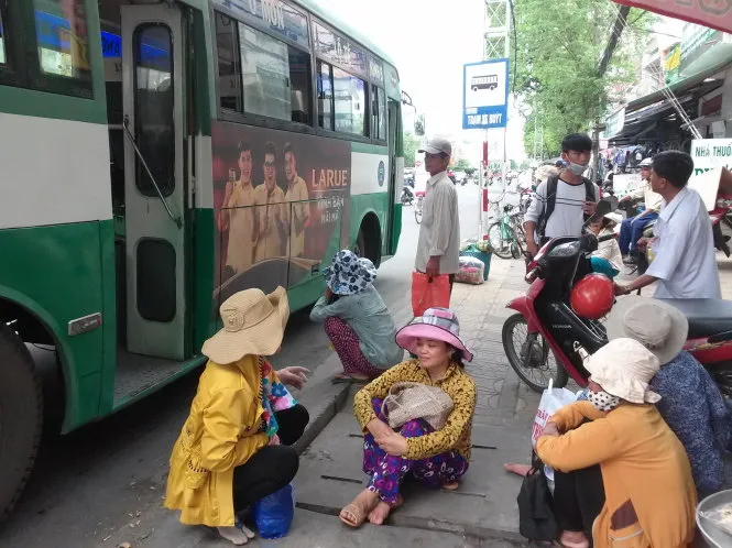 Người dân chờ đón xe buýt tại trạm dừng chân gần siêu thị
